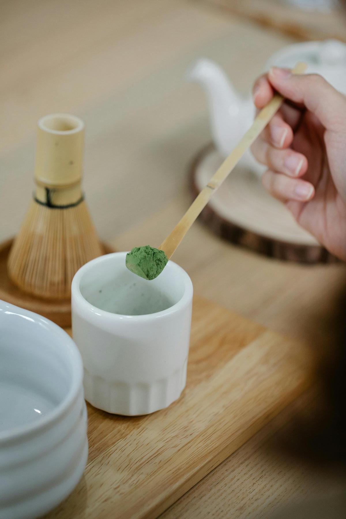 Scooping matcha powder into bowl