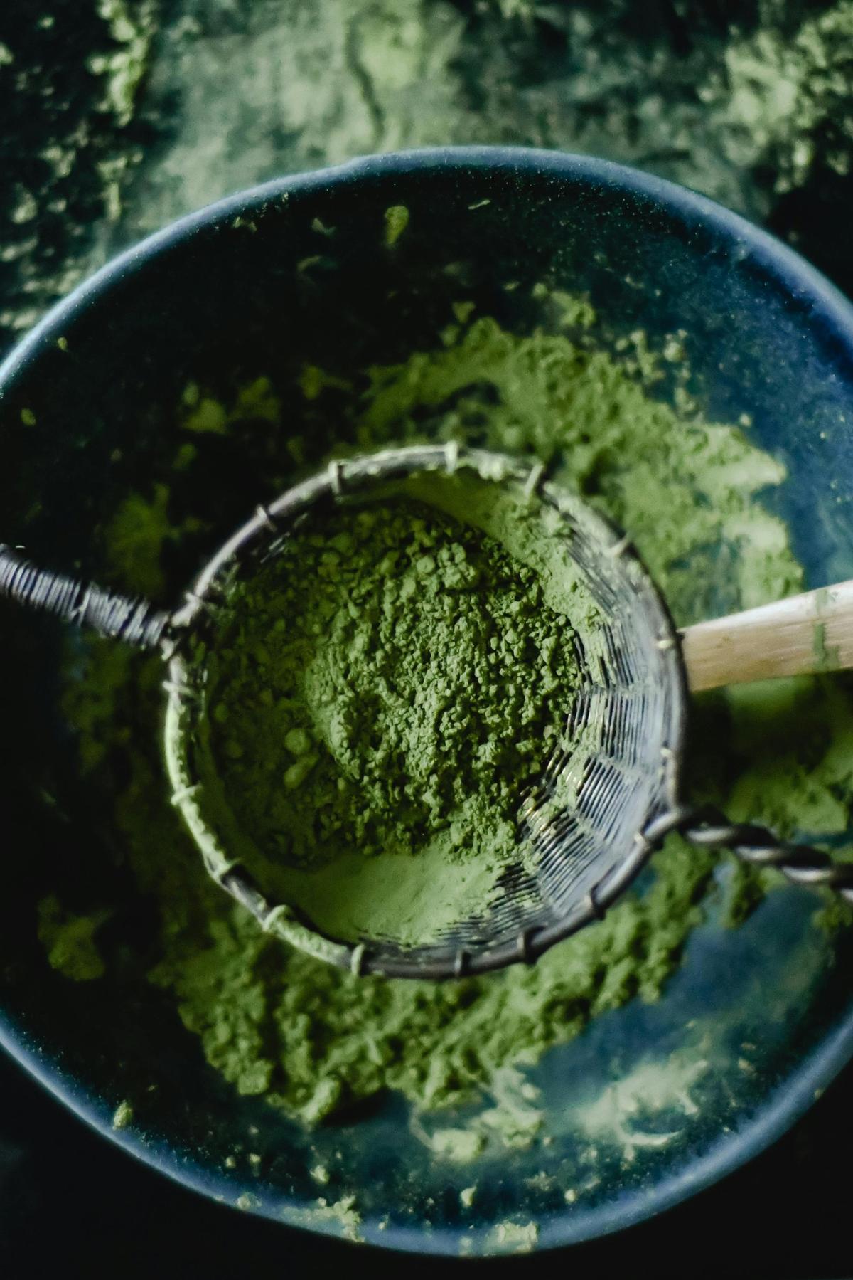 Sifting matcha powder through fine sieve